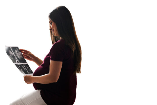 Pregnant woman looking at ultrasound scans