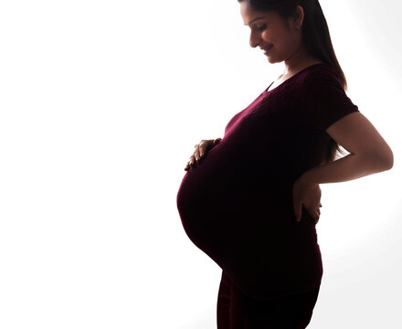 Pregnant woman looking at her stomach