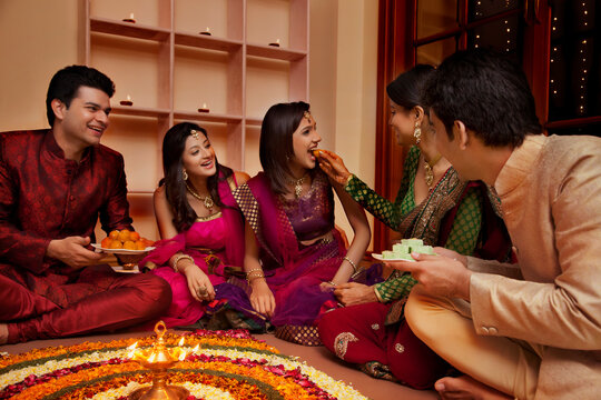 Woman feeding her friend sweets