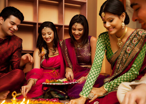 Friends making a rangoli