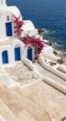 Fototapeta premium White island buildings with bougainvillea cascading to sea