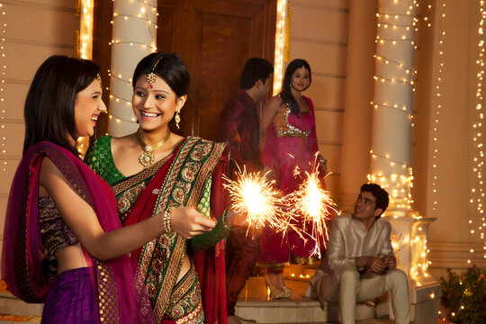 Women playing with sparklers