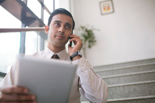 Executive talking on mobile phone