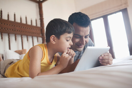 Father and son looking at a digital tablet