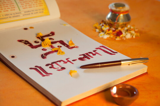 Lakshmi puja with ledger book,diya and a pen