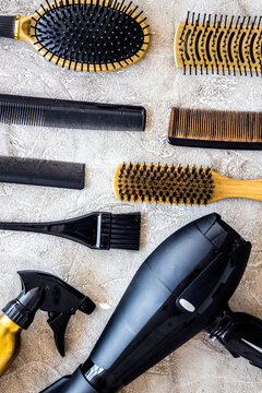 Combs and hairdress tools on stone table background top view