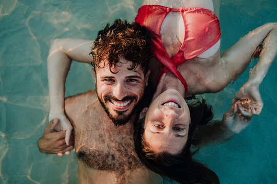 A man and a woman swim in the sea during a summer vacation in Ibiza