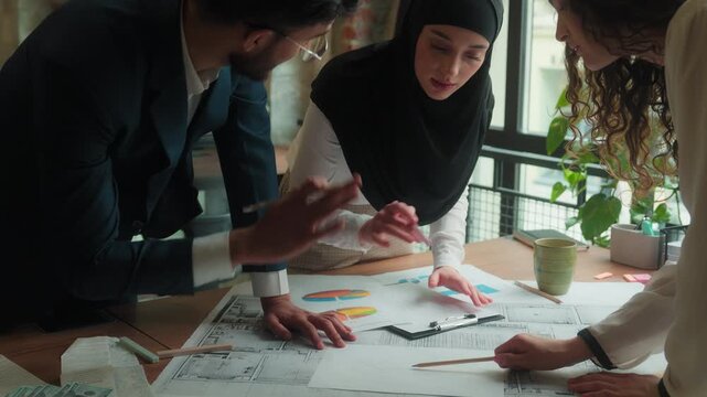 Multiracial business team arguing discussing stats blueprint architecture designers architects diverse businessman businesswomen talking difficulty problem documents analyzing drafting design project