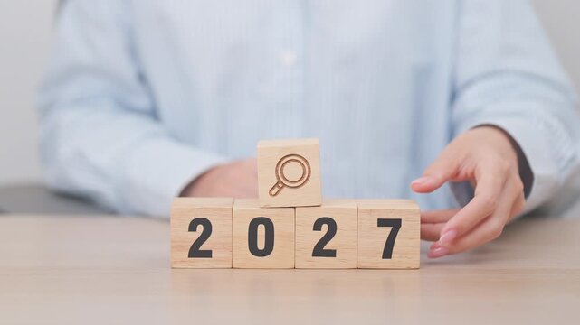 2027 year block with magnifying glass icon. SEO, Search Engine Optimization, hiring , Advertising, Idea, Strategy, marketing, Keyword, Content and New Year start concepts