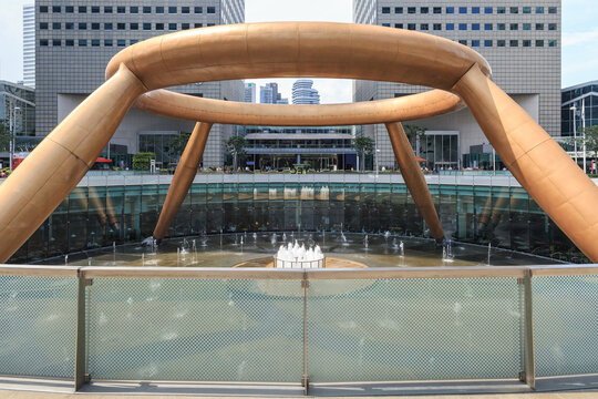 Fountain of Wealth at Suntec City in Singapore, featuring its iconic bronze ring sculpture surrounded by modern office buildings and water fountains
