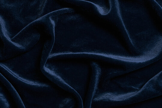 Luxury navy blue velvet fabric background texture with soft folds