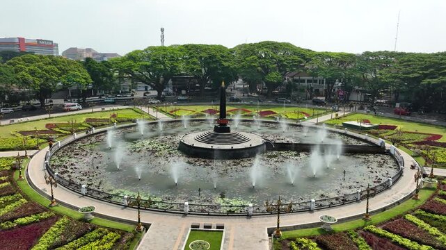 Aerial Orbit Around Alun Alun Tugu Monument and Fountain Public Square in Malang East Java Indonesia with Traffic