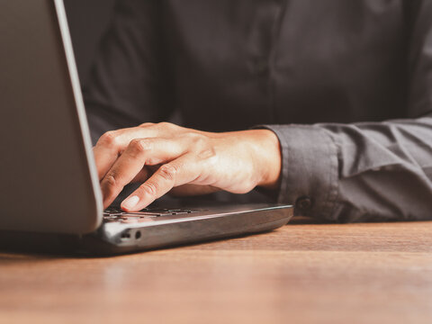 Close Up of Person Using Laptop at Desk