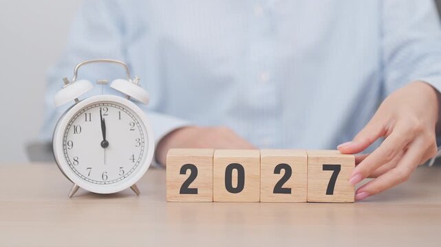 2026 end year to Happy New Year 2027 with vintage alarm clock. Christmas, New Start, Resolution, countdown, Goals, Plan, Action and Motivation Concept