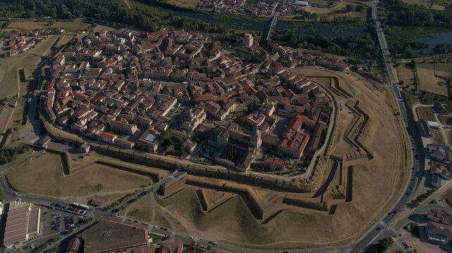 Cinematic aerial drone footage of Ciudad Rodrigo, a historic fortified city in Salamanca, Spain. Features medieval walls, cathedral, and traditional architecture surrounded by scenic countryside.