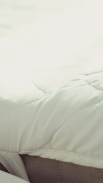 Cleaning a mattress with a vacuum cleaner nozzle close up shot