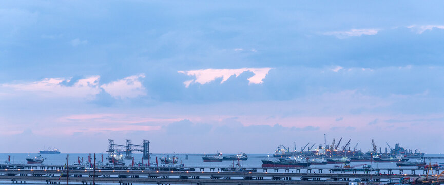 Industry landscape on sunset Engineering shipping crane depot at logistic export terminal control. Silhouette Warehouse freight background container yard loading quayside harbor port with copyspace