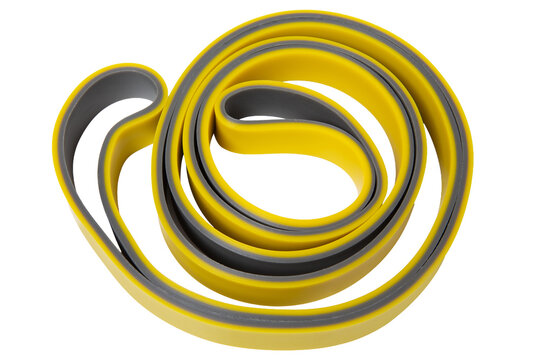 Yellow and grey resistance band loop for fitness training isolated on white background. Heavy duty rubber exercise pull up band coiled top view
