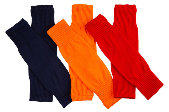 Set of colorful footless football socks isolated on white background. Navy blue, orange and red soccer calf sleeves top view