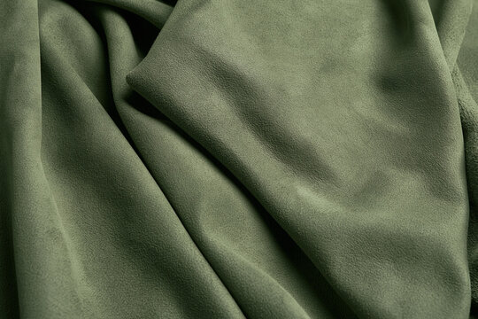 Sage olive green suede leather fabric macro background with smooth texture