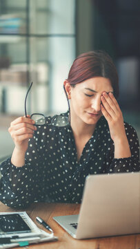 Businesswoman with eye pain at the office