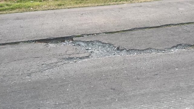 Damaged Asphalt Road Surface with Deep Cracks