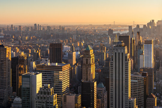 Elevated cityscape of Midtown Manhattan at sunset with skyscrapers and Brooklyn in the distance, New York City, USA