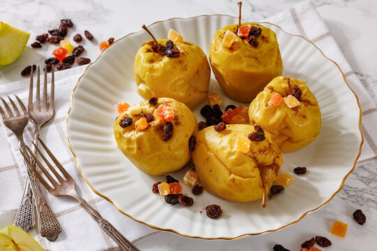 Whole Baked apples on a white plate