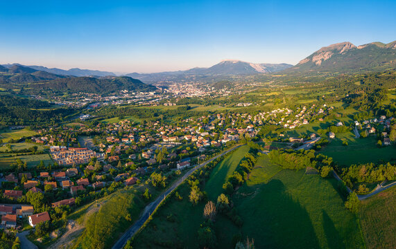 Aerial panoramic view of the village of Romette overlooking the Gap Basin with Ceuze and Charance mountains in morning light. Hautes-Alpes, French Alps, France
