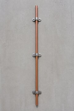 Copper Conductor Secured to Concrete Wall