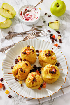 Whole Baked green apples on a white plate