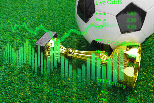 Sports betting statistics with a soccer ball and trophy on green grass