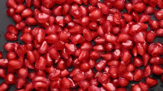 Rotating Red Anar Seeds with Juicy Glossy Texture in Angled Macro Food Shot