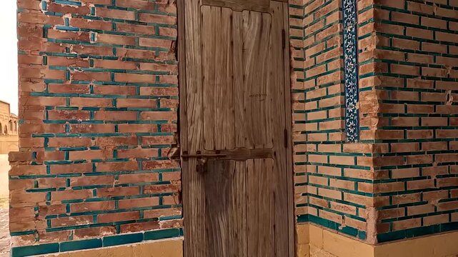 Close Up Of Weathered Wooden Door Set In Ancient Brick Wall With Traditional Blue Glazed Tiles At Makli