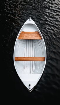 Aerial View of White Boat on Dark Water: Serene Minimalist Composition