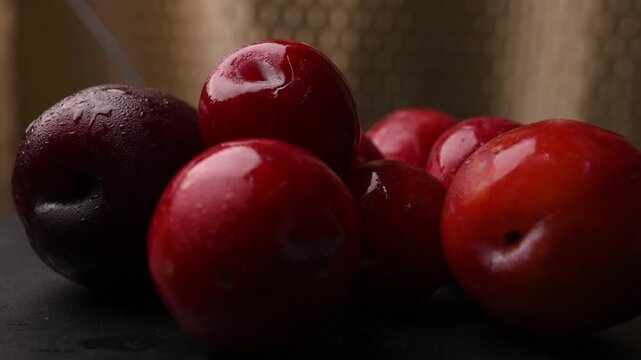 Rotating Fresh Red Alu Bukhara Plums Grouped Together Closeup Food Video