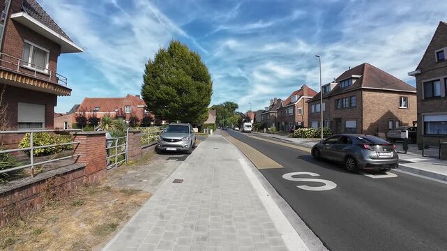 Walking hyperlapse along Legeweg street in suburban Sint-Andries, Bruges, Belgium