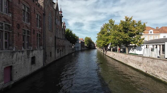 Static view over canal from Blinde-Ezelbrug bridge with dramatic reflection, historic center of Bruges, Belgium