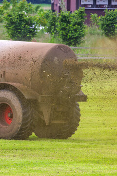 A Dutch farmer spreads manure on his grass fields