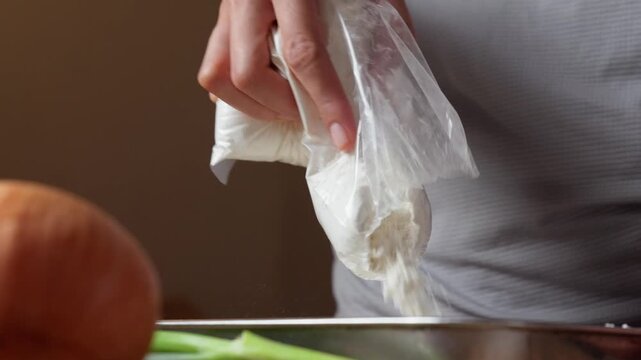 Pouring all purpose flour from a bag into a mixing tray