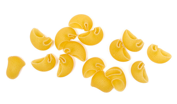 Dry yellow pipe rigate pasta with ribbed, curved shapes pile isolated on white background, top view