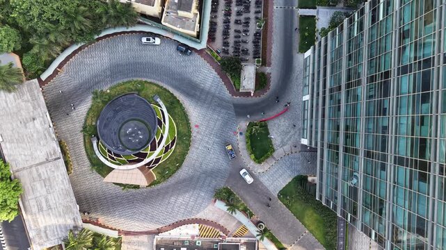 Modern glass office building with a circular landscaped courtyard seen from above