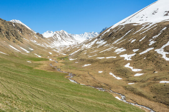 Trekking in Caucasus Mountains spring landscape. Karachay-Cherkessia, Russia