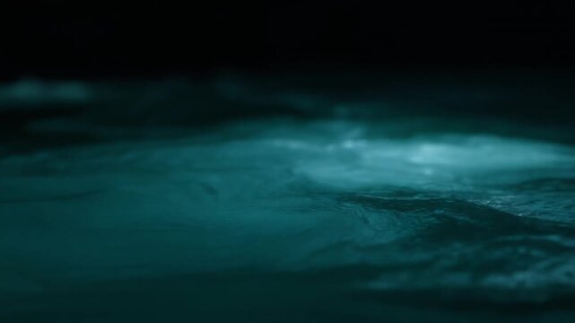 Dark teal-blue water swirling in gentle continuous currents
