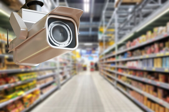 Retail security. Surveillance camera monitors supermarket aisles and merchandise, providing video surveillance, theft prevention and store safety control.