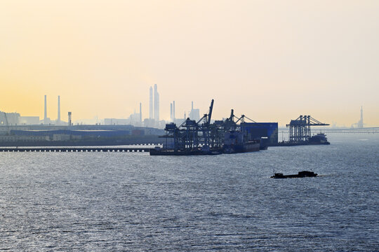 Sunset over industrial shipping port
