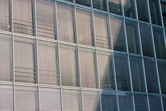 Modern building facade with horizontal metal window blinds