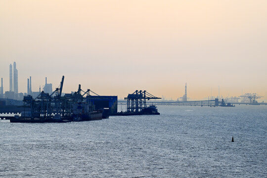 Sunset over industrial shipping port