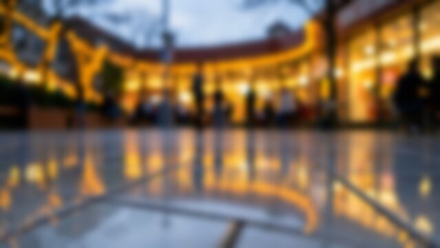 Blurred evening shopping center with warm light reflections for