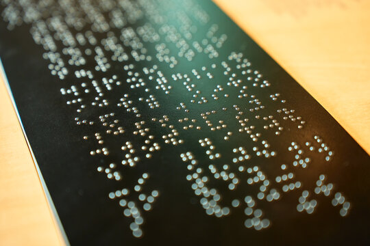 Braille text on tactile information sign